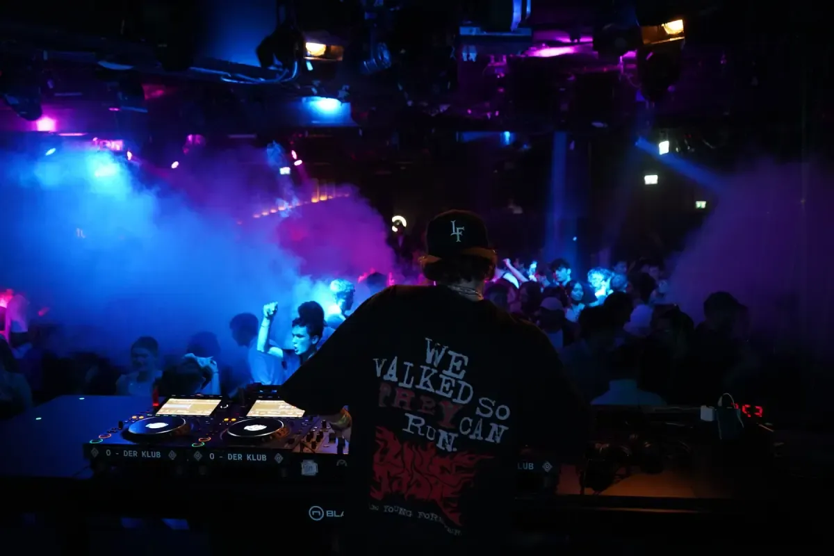 C-MON behind the decks with a crowd