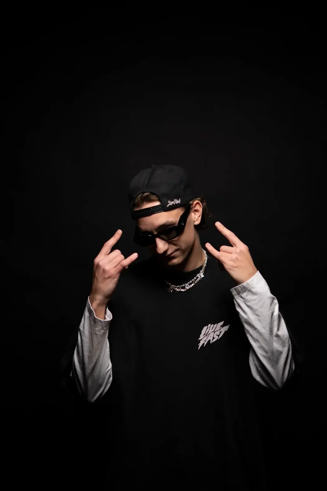 C-MON portrait with hands raised