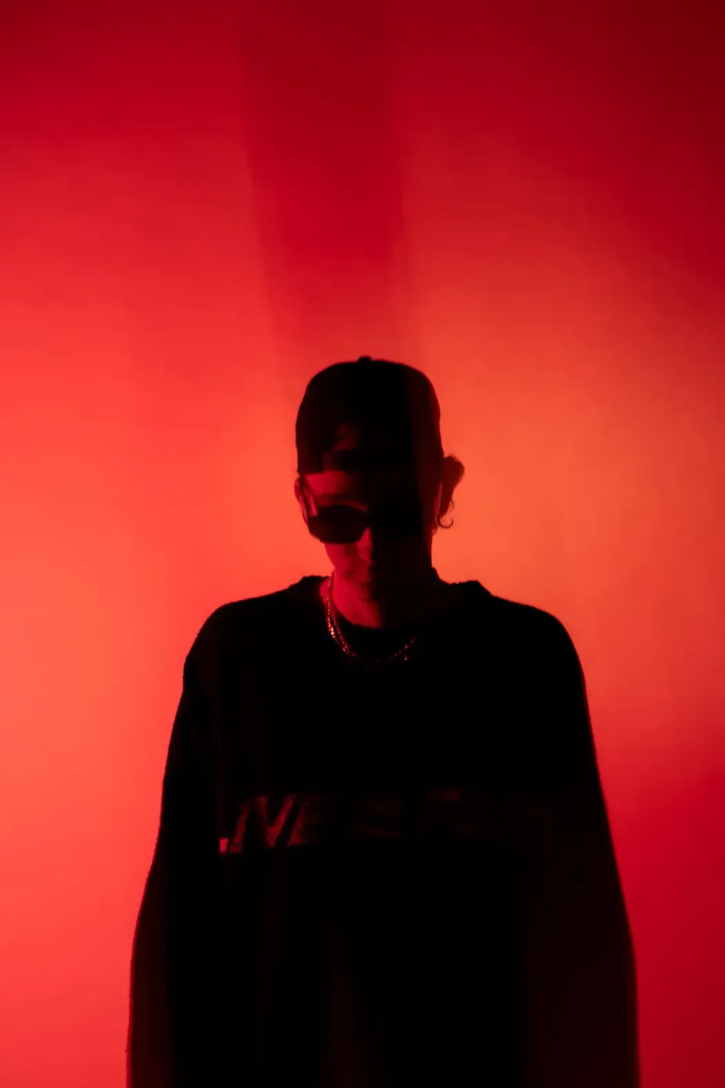 C-MON in red silhouette lighting